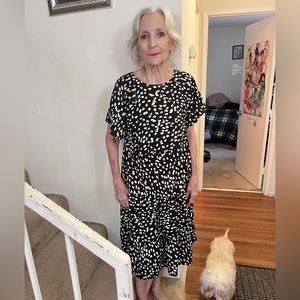 Women’s knee length dress, spots (white) on either black or dark blue.